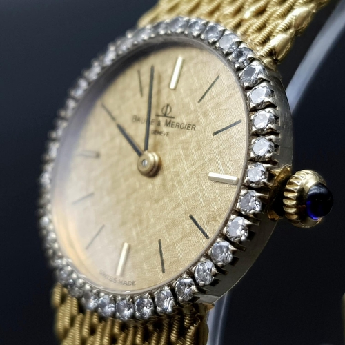 163 - An 18 K yellow gold BAUME & MERCIER ladies watch. 24 mm dial with gold face, bezel with diamonds and... 