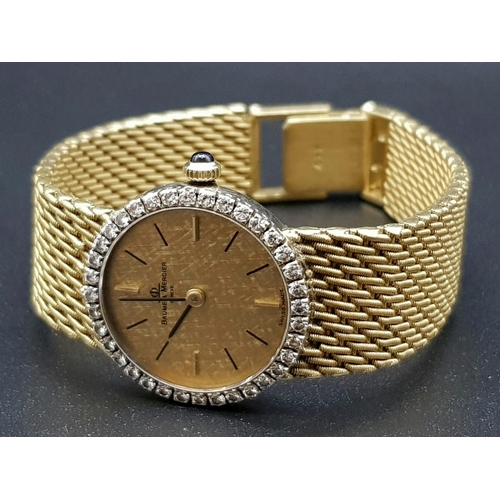 163 - An 18 K yellow gold BAUME & MERCIER ladies watch. 24 mm dial with gold face, bezel with diamonds and... 