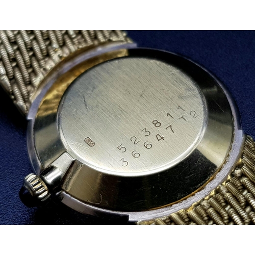 163 - An 18 K yellow gold BAUME & MERCIER ladies watch. 24 mm dial with gold face, bezel with diamonds and... 