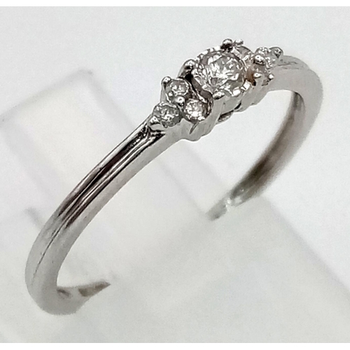 558 - 9K WHITE GOLD DIAMOND 7 STONE RING 1.3G SIZE L 0.10CT