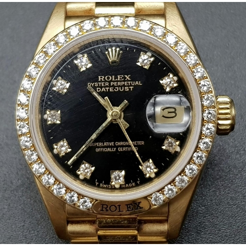 66 - An 18 K yellow gold ladies ROLEX DATEJUST watch. 26 mm dial, black face with diamonds on hour marks ... 