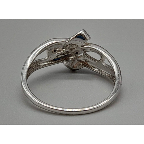 658 - A 9K White Gold Double-Crossover Diamond Ring in a Bow design. Size P. Total weight: 2.63g