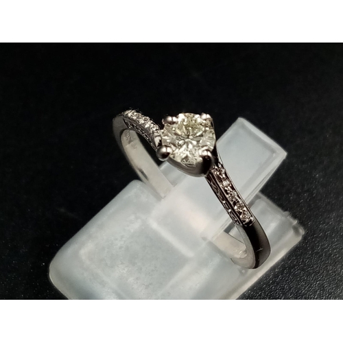 453 - An 18K White Gold Diamond Ring. Champagne centre stone with diamonds on shoulders. 0.30ct. Size M.
2... 