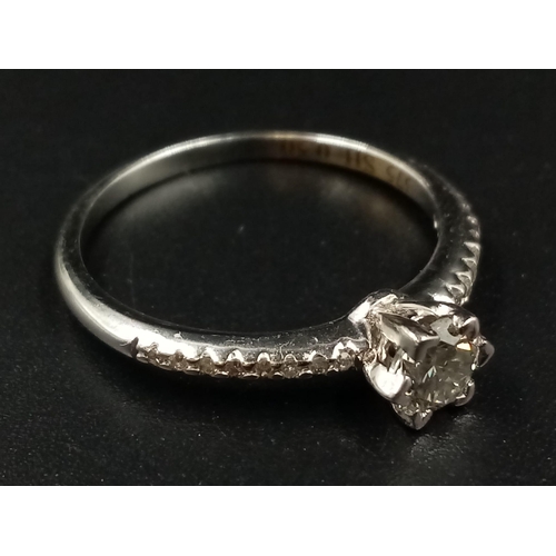 696 - A 9K White Gold Diamond Ring. Central diamond with diamonds on shoulders. 0.35 and 0.20ct. Size O.
1... 