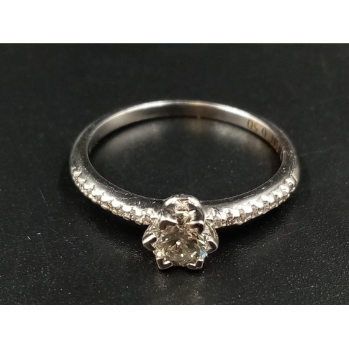 696 - A 9K White Gold Diamond Ring. Central diamond with diamonds on shoulders. 0.35 and 0.20ct. Size O.
1... 