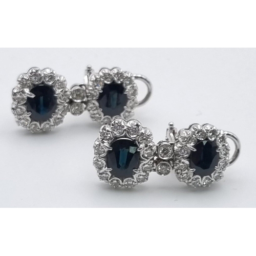 358 - An 18 K white gold pair of earrings with diamonds and blue/green sapphires. Length: 25 mm, total wei... 