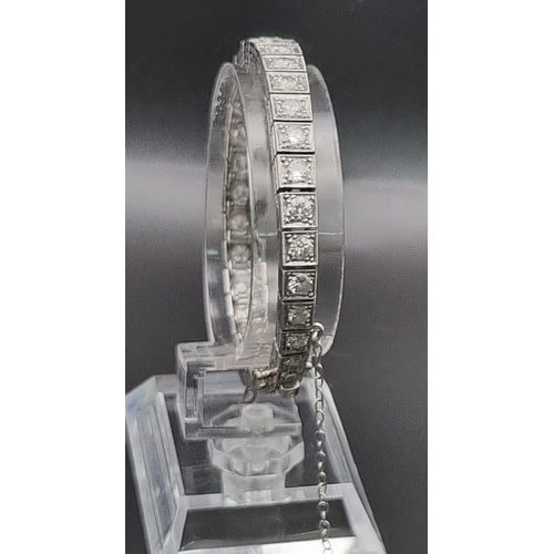 74 - A platinum tennis bracelet with large brilliant cut diamonds. Length: 18 cm, weight: 31.67 g.