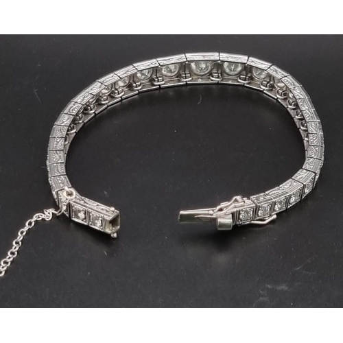 74 - A platinum tennis bracelet with large brilliant cut diamonds. Length: 18 cm, weight: 31.67 g.