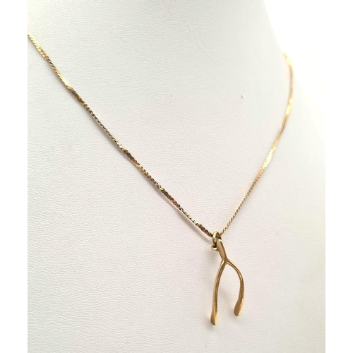 472 - A 9K Yellow Gold Wishbone Pendant on a 9K Yellow Gold Necklace.  3.28g total weight/