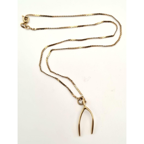 472 - A 9K Yellow Gold Wishbone Pendant on a 9K Yellow Gold Necklace.  3.28g total weight/