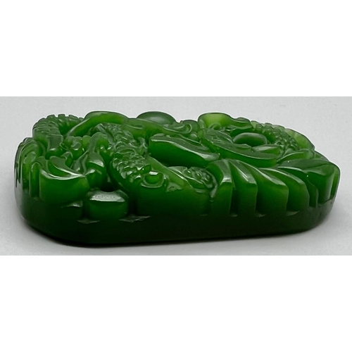 563 - A Green Jade Dragon Pendant. 5.5cm.