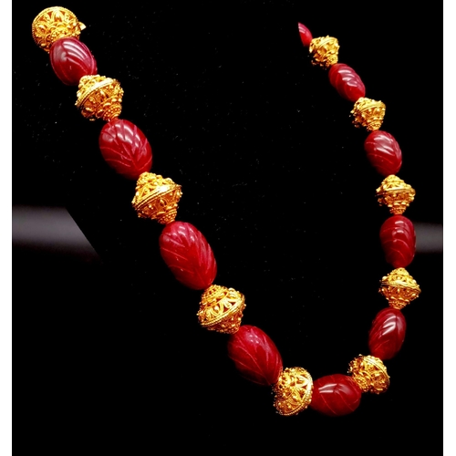 142 - An impressive, Indian, hand carved ruby necklace and earrings set in a presentation box. Necklace le... 