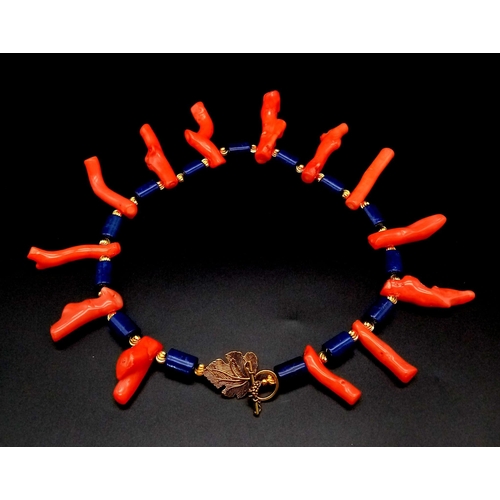 226 - A fabulous, lapis lazuli and large branches of polished Pacific red coral necklace and earrings set.... 