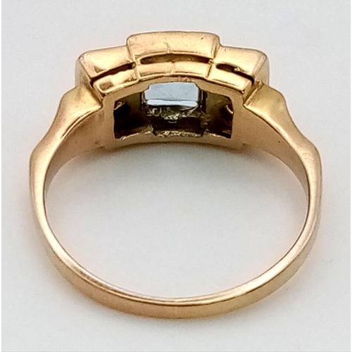 269 - An 18K Yellow Gold Topaz and Diamond Ring. Central square cut topaz with two diamonds either side. T... 