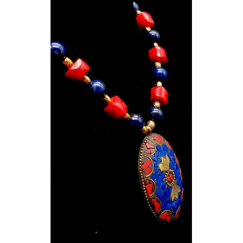 303 - A Nepalese, ethnic, necklace and earrings set with lapis lazuli and red coral. Necklace length: 48 c... 