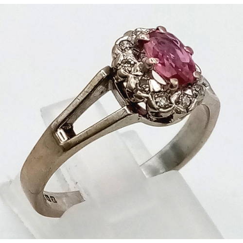 87 - A Vintage 18K White Gold Natural Burmese Ruby and Diamond Ring. Central ruby surrounded with a halo ... 