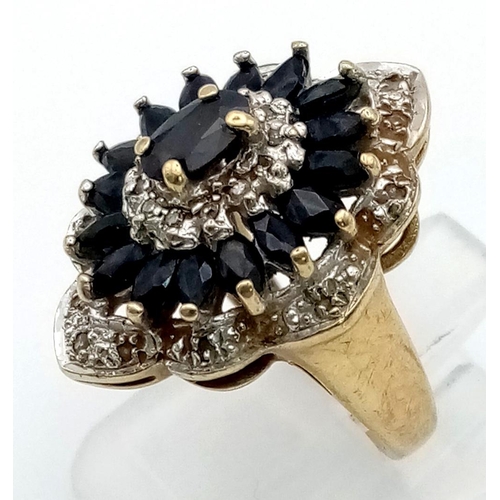 119 - 9K YELLOW GOLD DIAMOND & SAPPHIRE CLUSTER RING 5.2G. SIZE K.