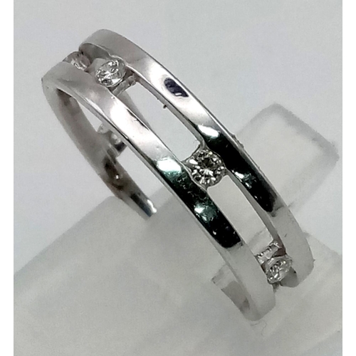 139 - 18K WHITE GOLD DIAMOND OPEN BAND RING. 0.15CT 4G. SIZE O