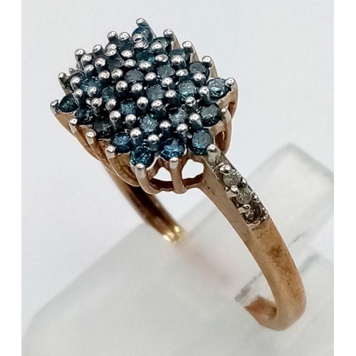 322 - 9K YELLOW GOLD BLUE DIAMOND CLUSTER RING. 0.50CT. 3.1G SIZE P.