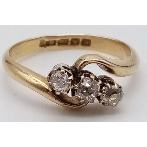 734 - An 18K Yellow Gold Diamond Three-Stone Crossover Ring. Size K. 2.7g total weight.