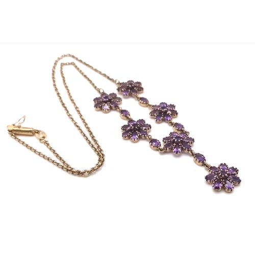 713 - A 9K Yellow Gold and Amethyst Necklace. Amethyst floral decoration and drop pendant. 44cm.  9.59g to... 