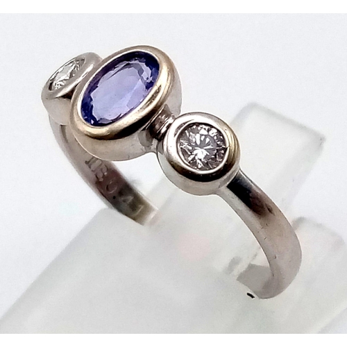 727 - An 18K White Gold Purple Sapphire and Diamond Ring.
Central purple sapphire with a diamond either si... 