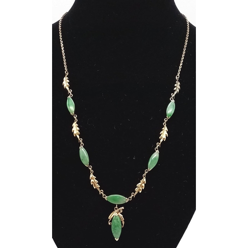 470 - A 14K yellow Gold Jade Oval Cabochon Necklace. A belcher link necklace decorated with five jade cabo... 