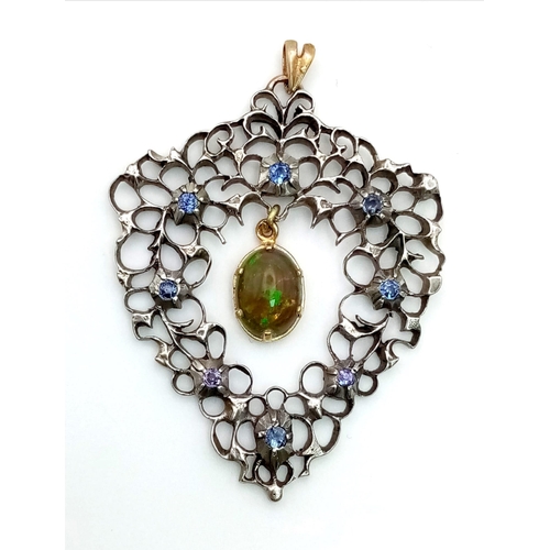 699 - An Antique Victorian Silver and Gold Pendant with a Hanging Black Opal and Blue Sapphires. 4.5 x 4cm... 