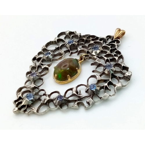 699 - An Antique Victorian Silver and Gold Pendant with a Hanging Black Opal and Blue Sapphires. 4.5 x 4cm... 