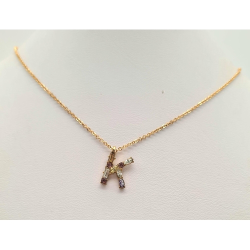 982 - GOLD TONE STONE SET INITIAL K PENDANT ON CHAIN