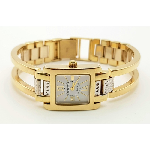 117 - A 14K Yellow and White Gold Geneve Quartz Ladies Watch. 14k gold strap and case - 22 x 16mm. White d... 