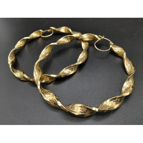 203 - A Pair of Large 14k Yellow Gold Twisted Hoop Earrings.
6cm inner diameter. 9.5g total weight. Ref -1... 