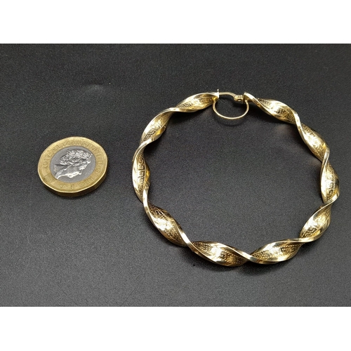 203 - A Pair of Large 14k Yellow Gold Twisted Hoop Earrings.
6cm inner diameter. 9.5g total weight. Ref -1... 