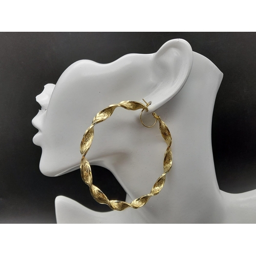 203 - A Pair of Large 14k Yellow Gold Twisted Hoop Earrings.
6cm inner diameter. 9.5g total weight. Ref -1... 