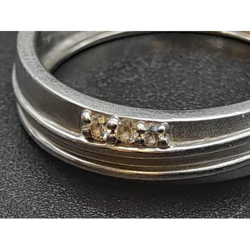 55 - A 950 Platinum Diamond Band Ring. Three small diamonds. Size Q. 5.19g total weight. Ref - 190