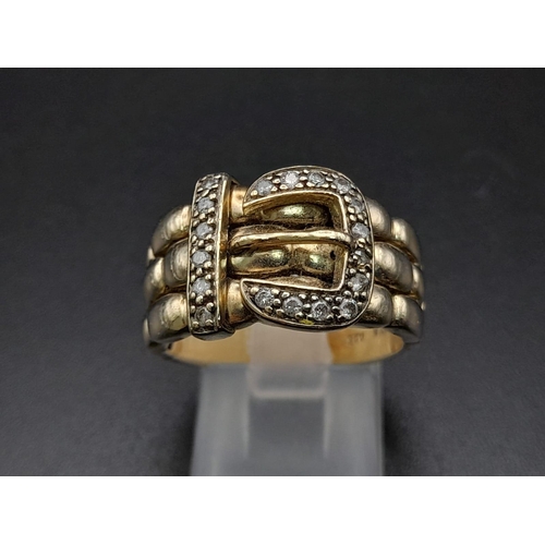 74 - A 9K Yellow Gold and Diamond Buckle Ring. 18 diamonds .25ct complement this keeper piece. Size Q. 9.... 