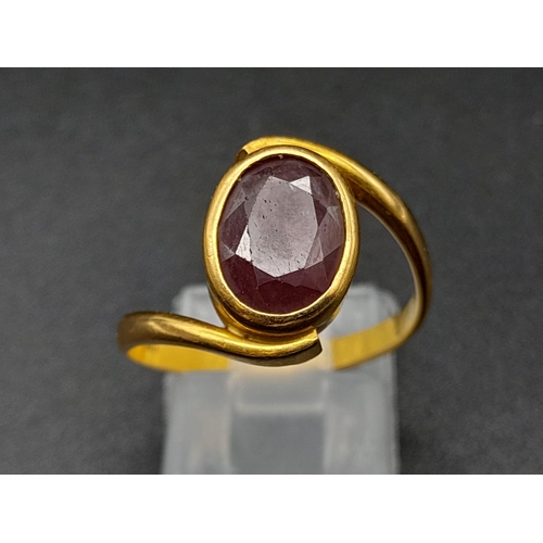 79 - A 22K Yellow Gold Red Stone Crossover Ring. Size Q. 4.87g total weight. A/F. Ref - 8667.