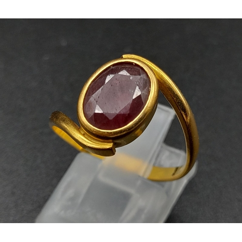 79 - A 22K Yellow Gold Red Stone Crossover Ring. Size Q. 4.87g total weight. A/F. Ref - 8667.