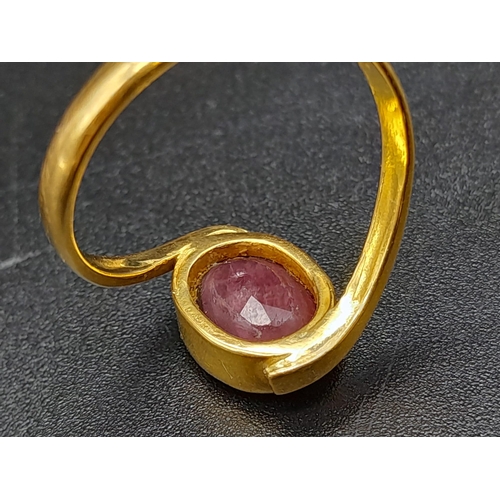 79 - A 22K Yellow Gold Red Stone Crossover Ring. Size Q. 4.87g total weight. A/F. Ref - 8667.