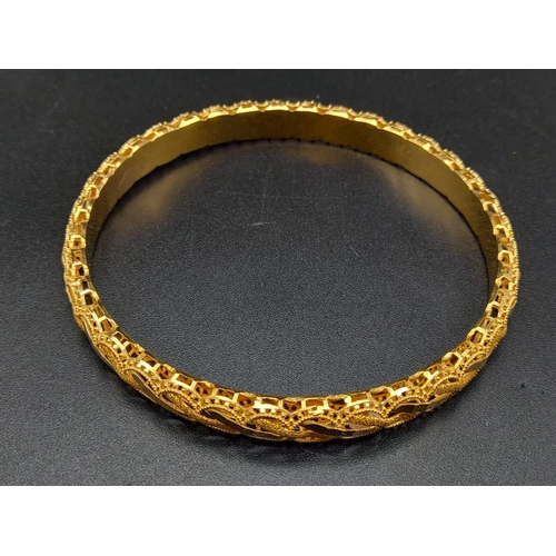 93 - An 21K Yellow Gold Fancy-Design Bangle. Perfect wedding jewellery. 6.5cm inner diameter. 13.2g. Ref ... 