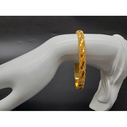 93 - An 21K Yellow Gold Fancy-Design Bangle. Perfect wedding jewellery. 6.5cm inner diameter. 13.2g. Ref ... 