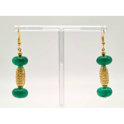 107 - A Chinese necklace and earrings set with large emerald cabochons and gold plated dragons, in a prese... 