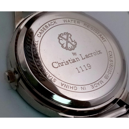 128 - A CHRISTIAN LACROIX ladies watch. 36 mm dial, white face with the designer’s emblem, white metal mes... 