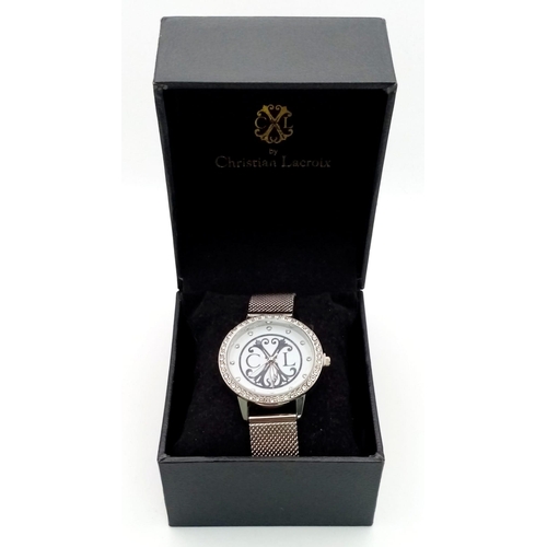 128 - A CHRISTIAN LACROIX ladies watch. 36 mm dial, white face with the designer’s emblem, white metal mes... 