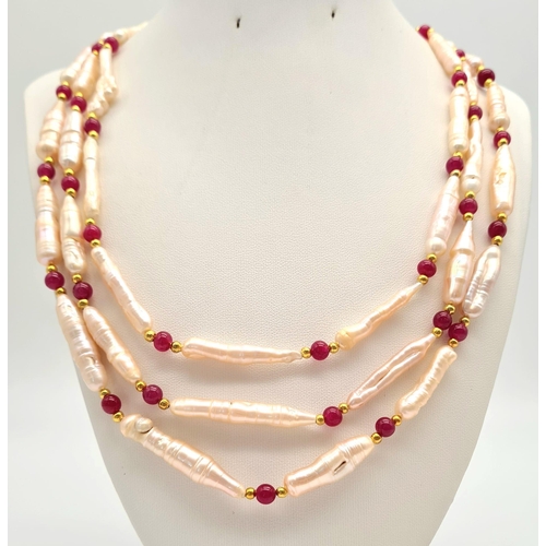 135 - A rarely seen, large Biwa pink pearls and round rubies three row necklace and earrings set in a pres... 