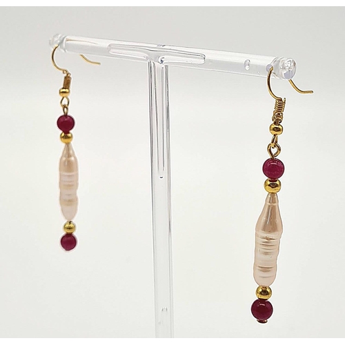 135 - A rarely seen, large Biwa pink pearls and round rubies three row necklace and earrings set in a pres... 