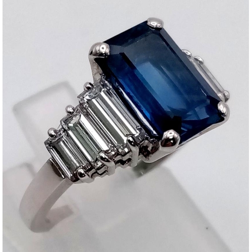 19 - A 14 K white gold ring with a beautiful emerald cut blue  sapphire (3 carats) and baguette diamonds ... 