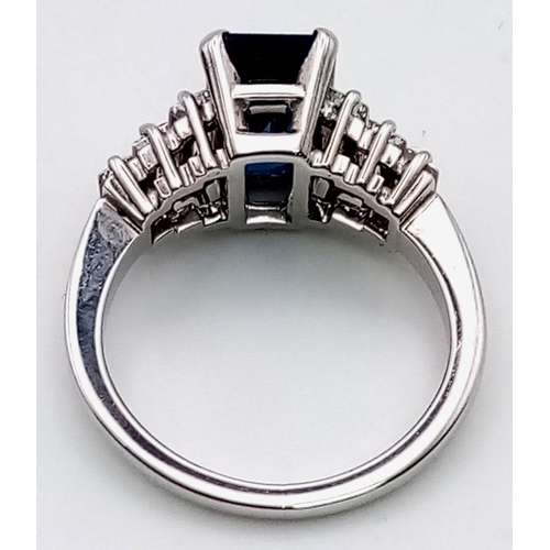 19 - A 14 K white gold ring with a beautiful emerald cut blue  sapphire (3 carats) and baguette diamonds ... 