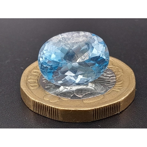 404 - An oval cut faceted blue topaz (9.25 carats) with GLA certificate. Dimensions: 14.02 x 10.62 x 8.28 ... 