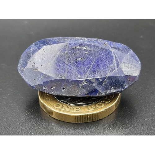 631 - An oval faceted blue sapphire composite (73.65 carats) with GLA certificate. Dimensions: 33.83 x 19.... 